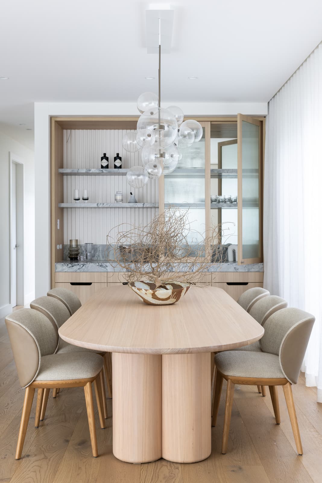 Renovated living and dining space with custom joinery by Structure Building